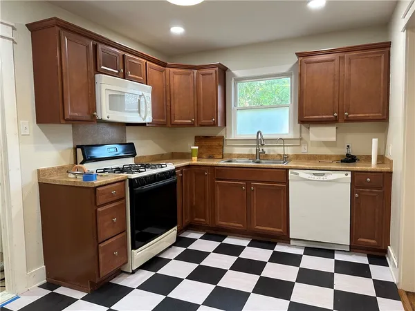 a kitchen with a stove sink and window