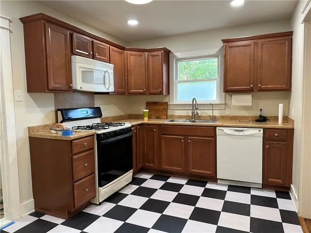 a kitchen with a stove sink and window
