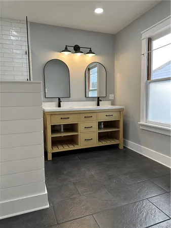 a bathroom with a double vanity sink and a mirror