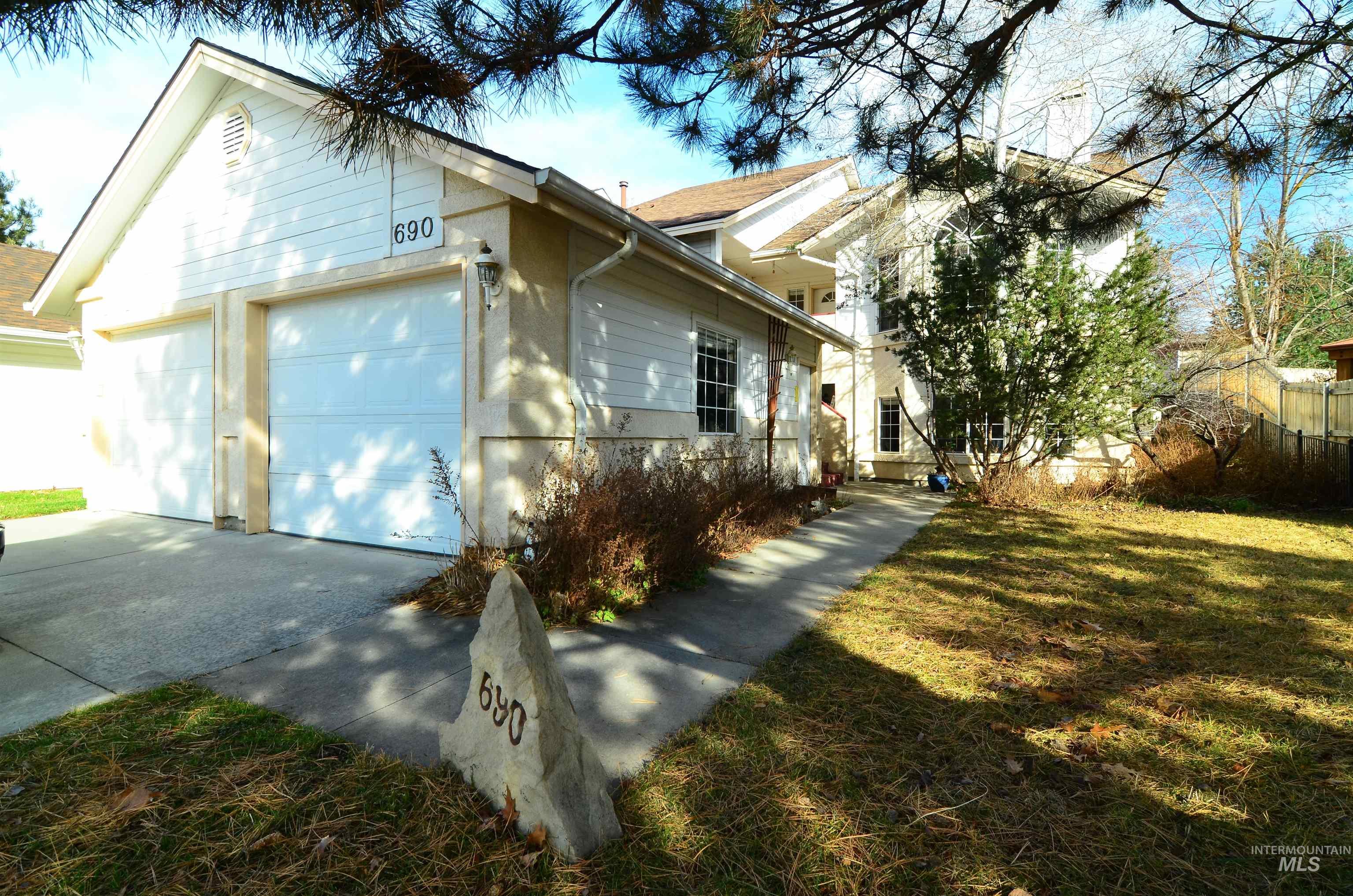 690 Granite Way Boise, ID 83712 - Photo 1 of 30 View of front facade with driveway, a front yard, and an attached garage