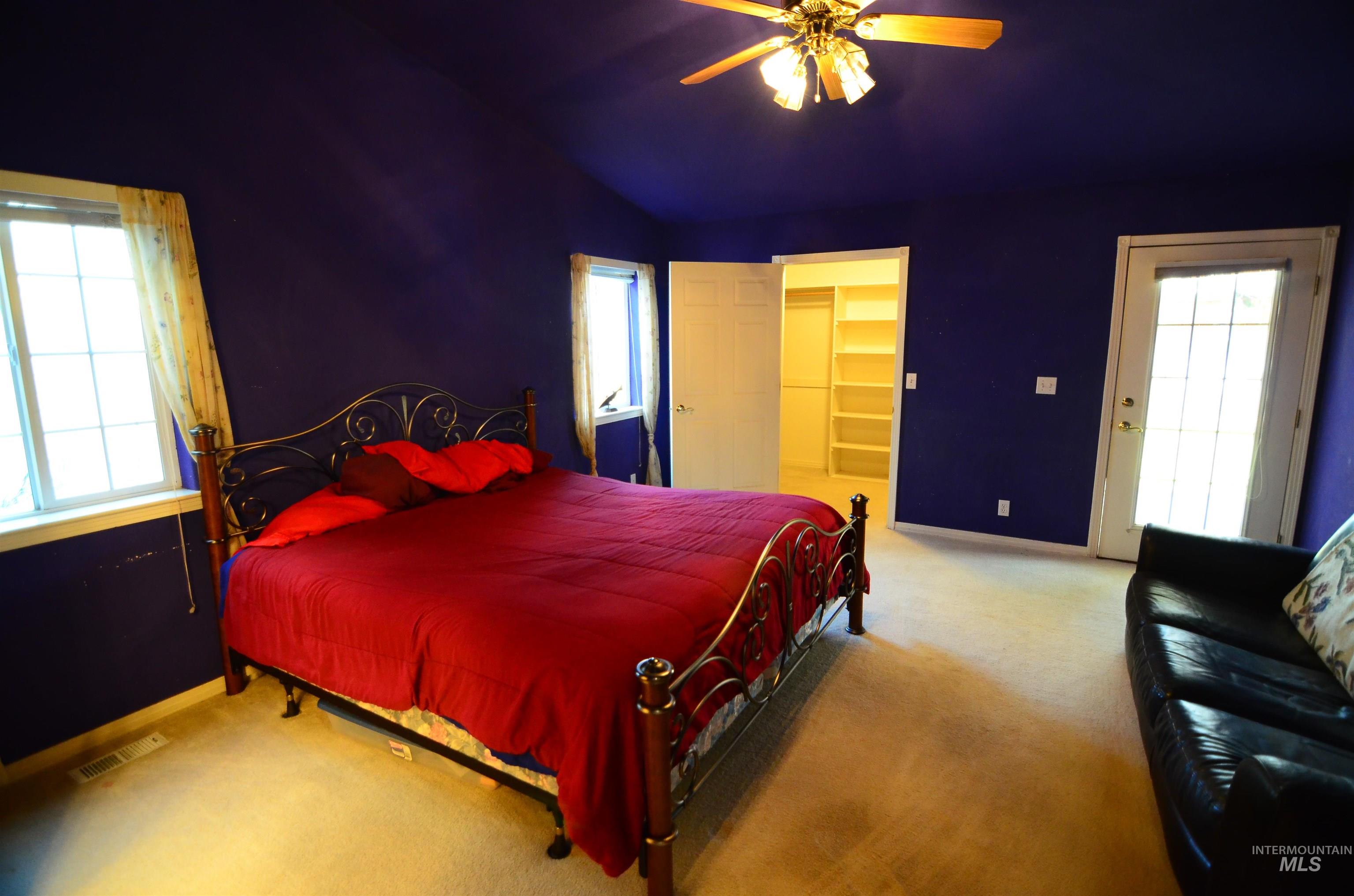 690 Granite Way Boise, ID 83712 - Photo 11 of 30 Bedroom featuring light colored carpet, a walk in closet, a ceiling fan, and access to exterior