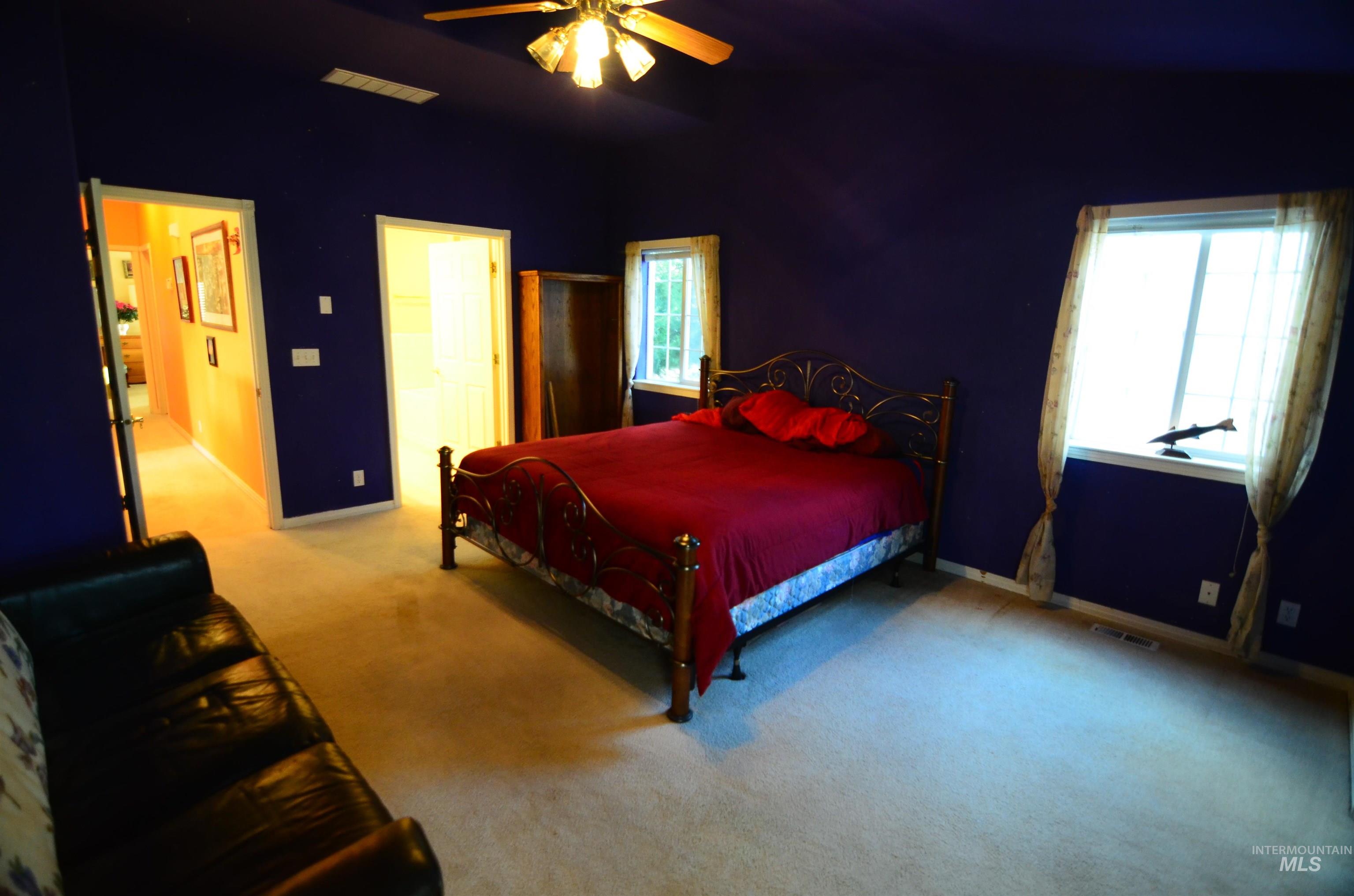 690 Granite Way Boise, ID 83712 - Photo 12 of 30 Bedroom featuring carpet flooring, a ceiling fan, and a spacious closet