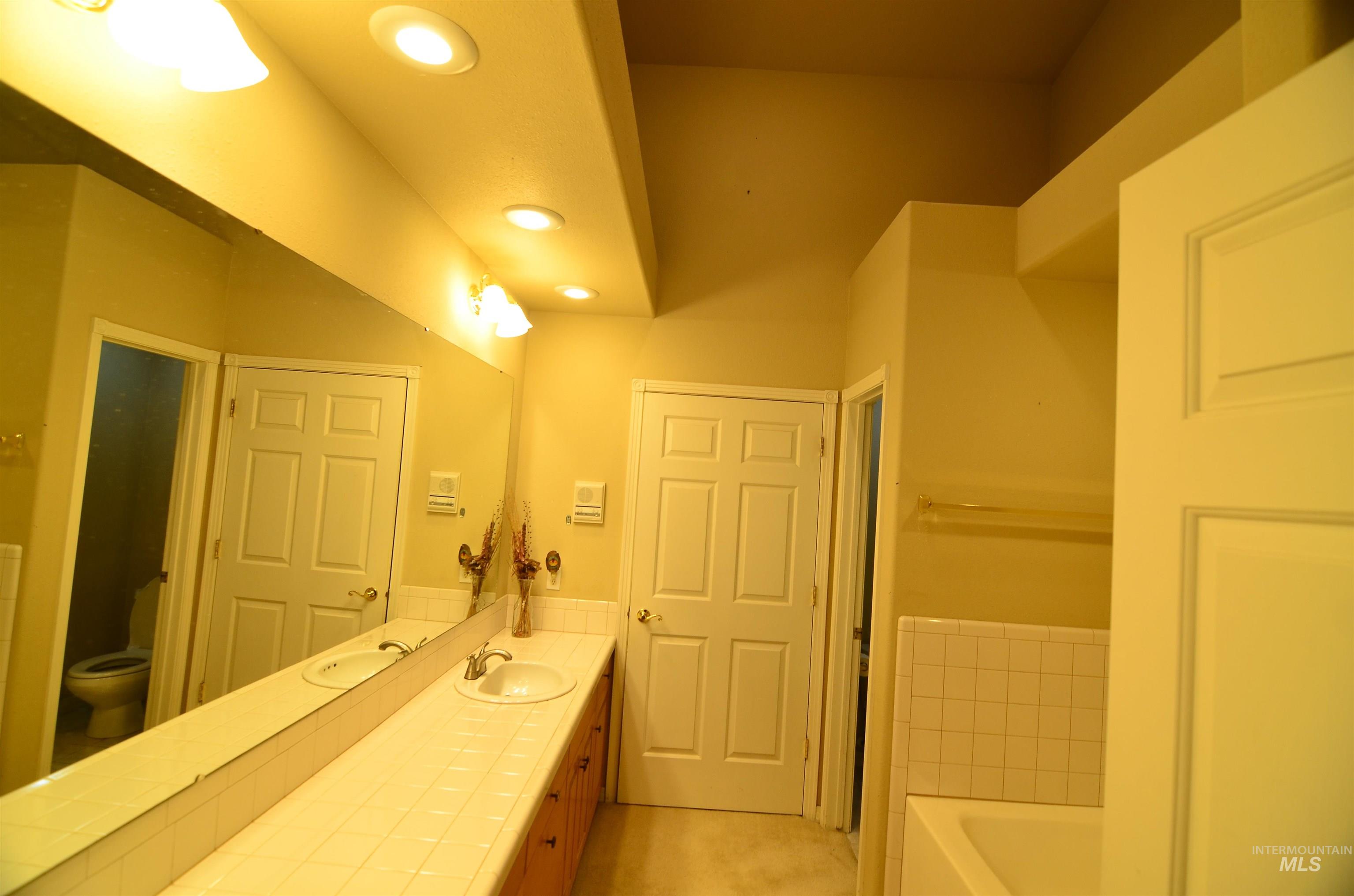 690 Granite Way Boise, ID 83712 - Photo 16 of 30 Bathroom with a garden tub, vanity, and recessed lighting
