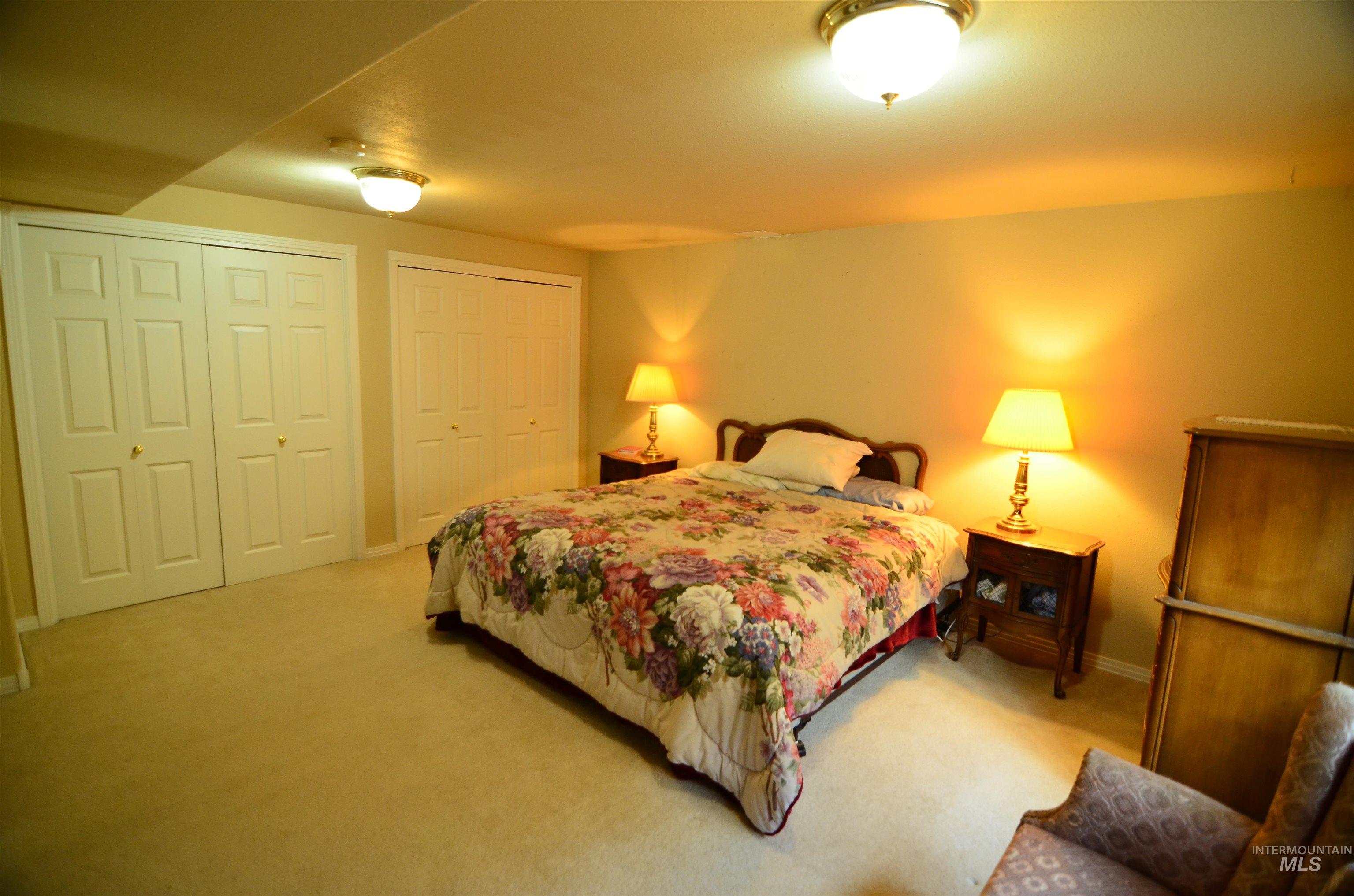 690 Granite Way Boise, ID 83712 - Photo 18 of 30 Bedroom featuring multiple closets and carpet flooring