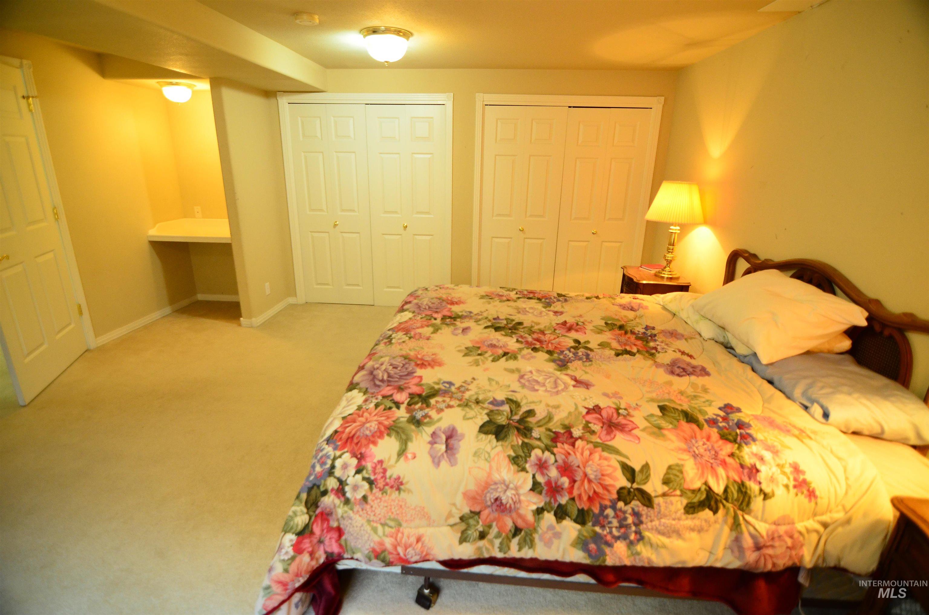 690 Granite Way Boise, ID 83712 - Photo 19 of 30 Bedroom with two closets and light colored carpet