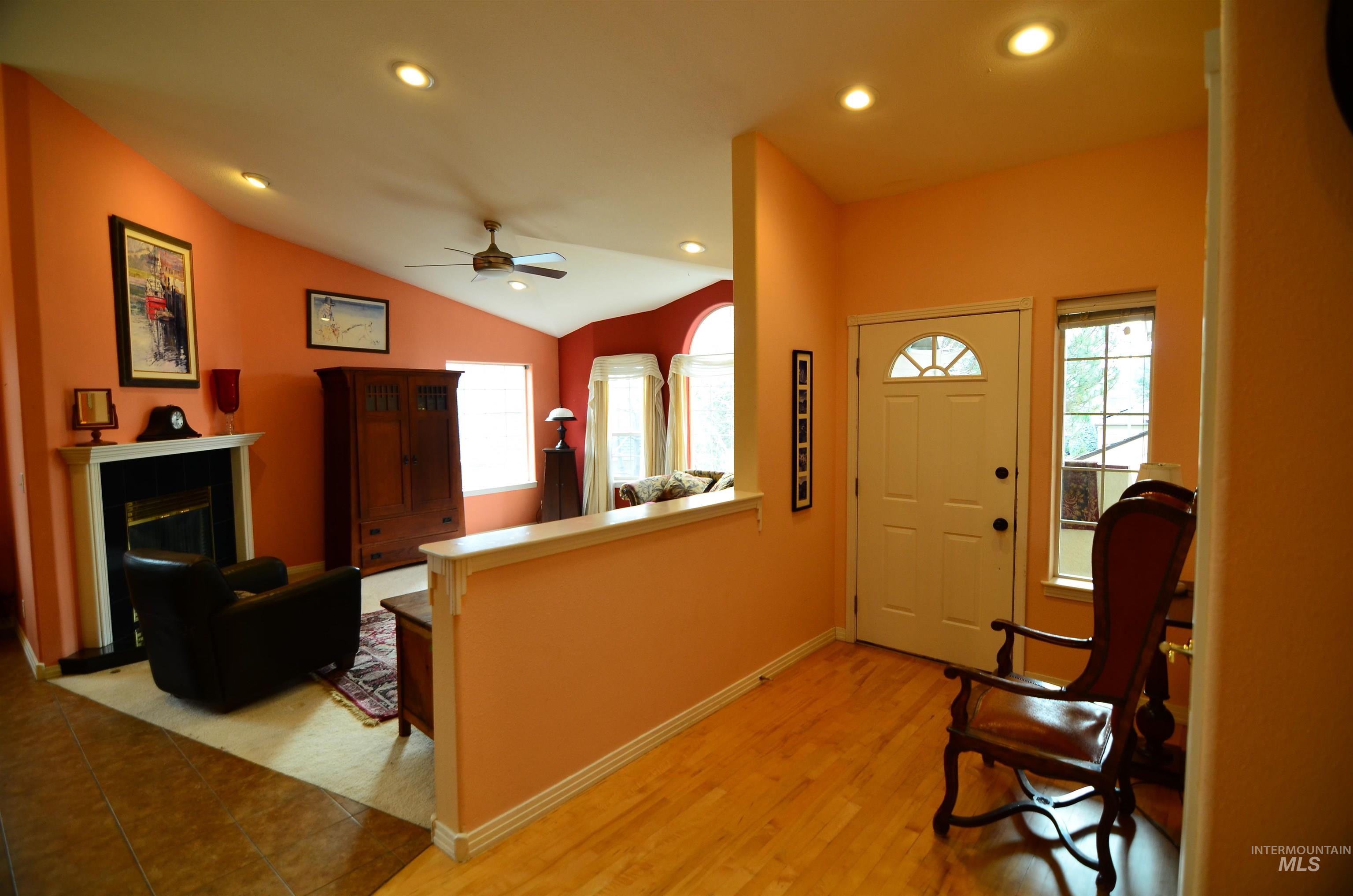 690 Granite Way Boise, ID 83712 - Photo 2 of 30 Entryway with recessed lighting, lofted ceiling, a glass covered fireplace, ceiling fan, and light wood finished floors