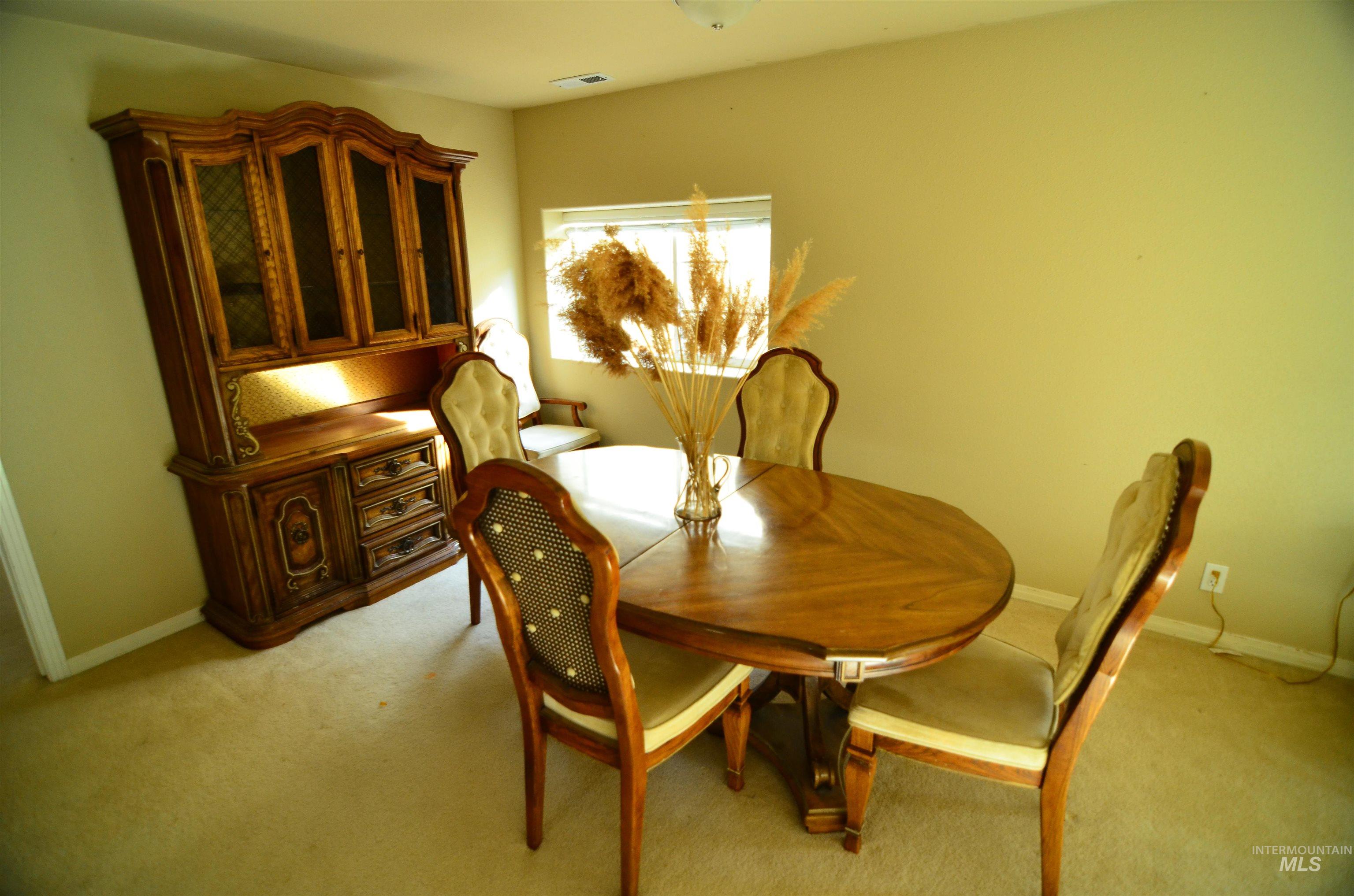 690 Granite Way Boise, ID 83712 - Photo 21 of 30 Dining room featuring light colored carpet and baseboards