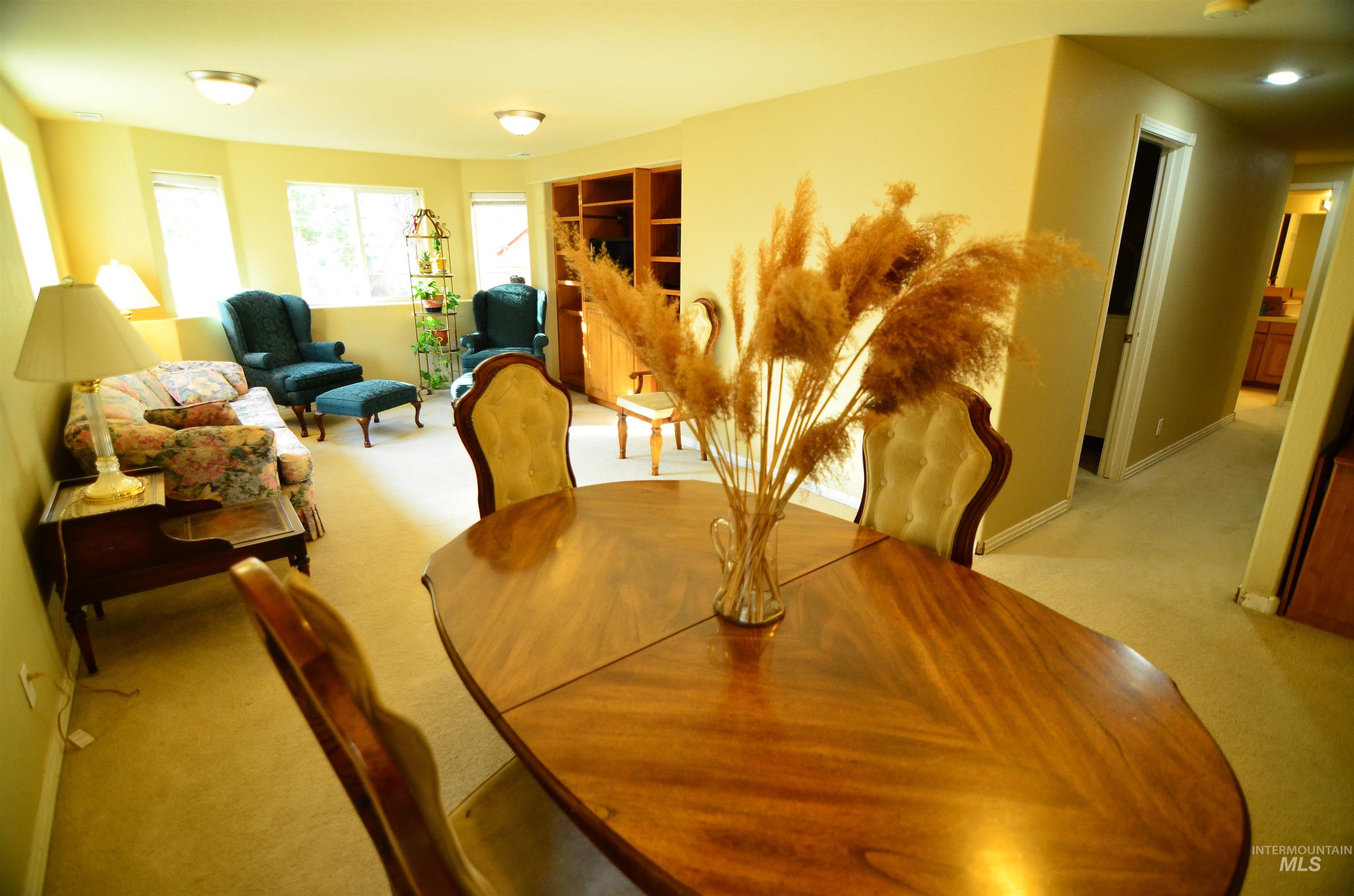 690 Granite Way Boise, ID 83712 - Photo 22 of 30 Dining area with light carpet and baseboards