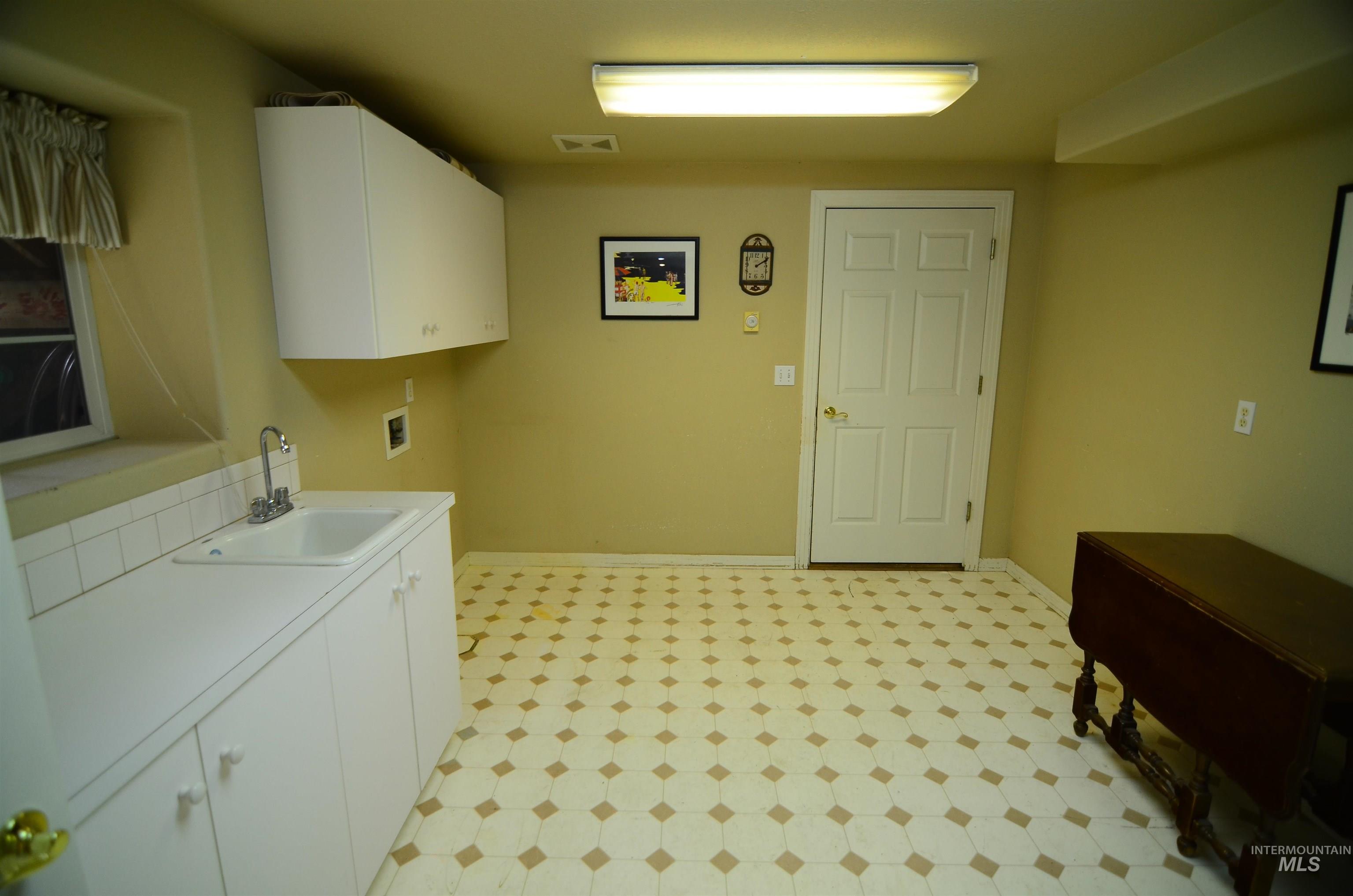 690 Granite Way Boise, ID 83712 - Photo 24 of 30 Laundry room featuring light floors, washer hookup, and cabinet space