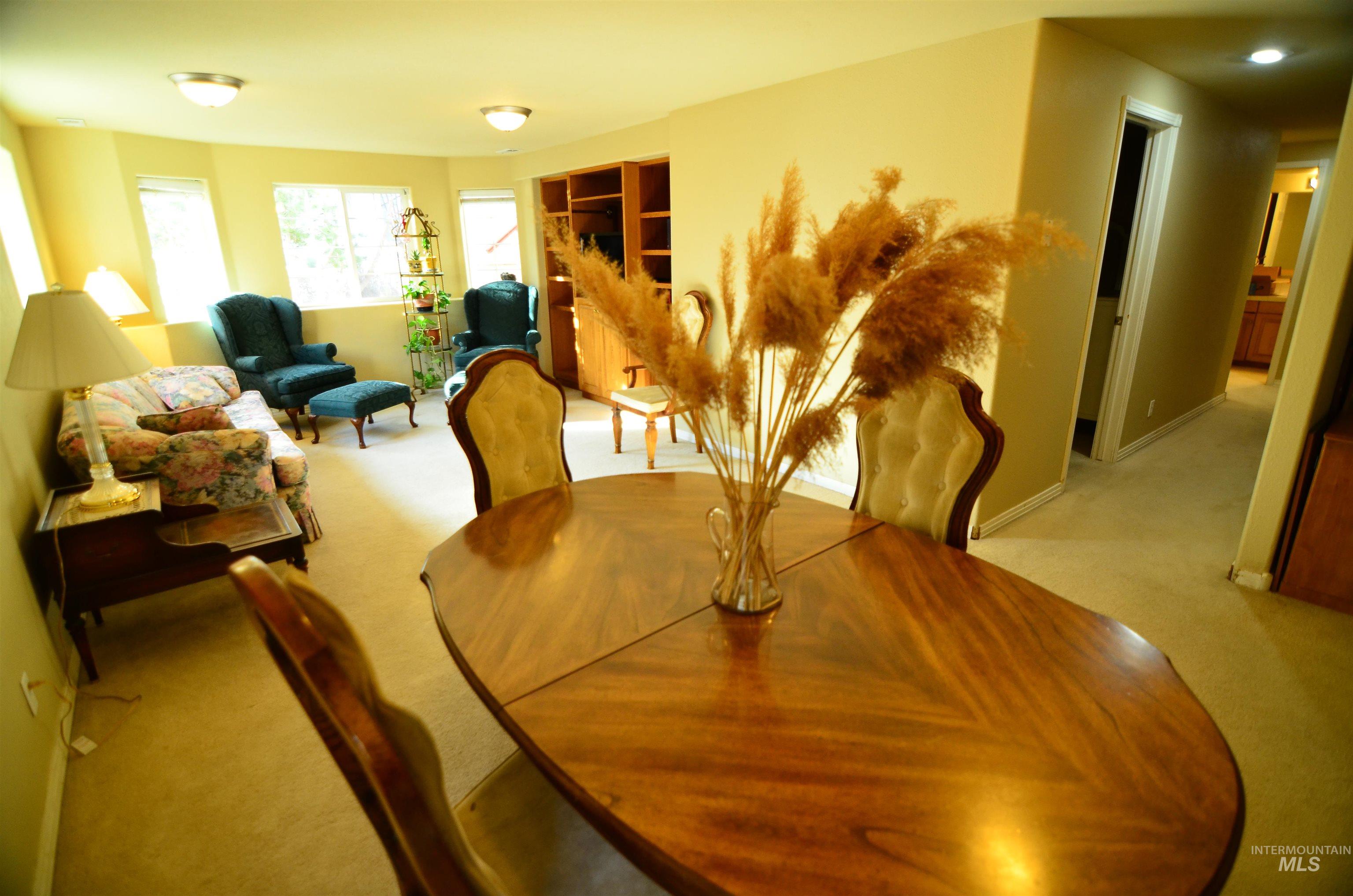 690 Granite Way Boise, ID 83712 - Photo 26 of 30 Dining area with light carpet and baseboards