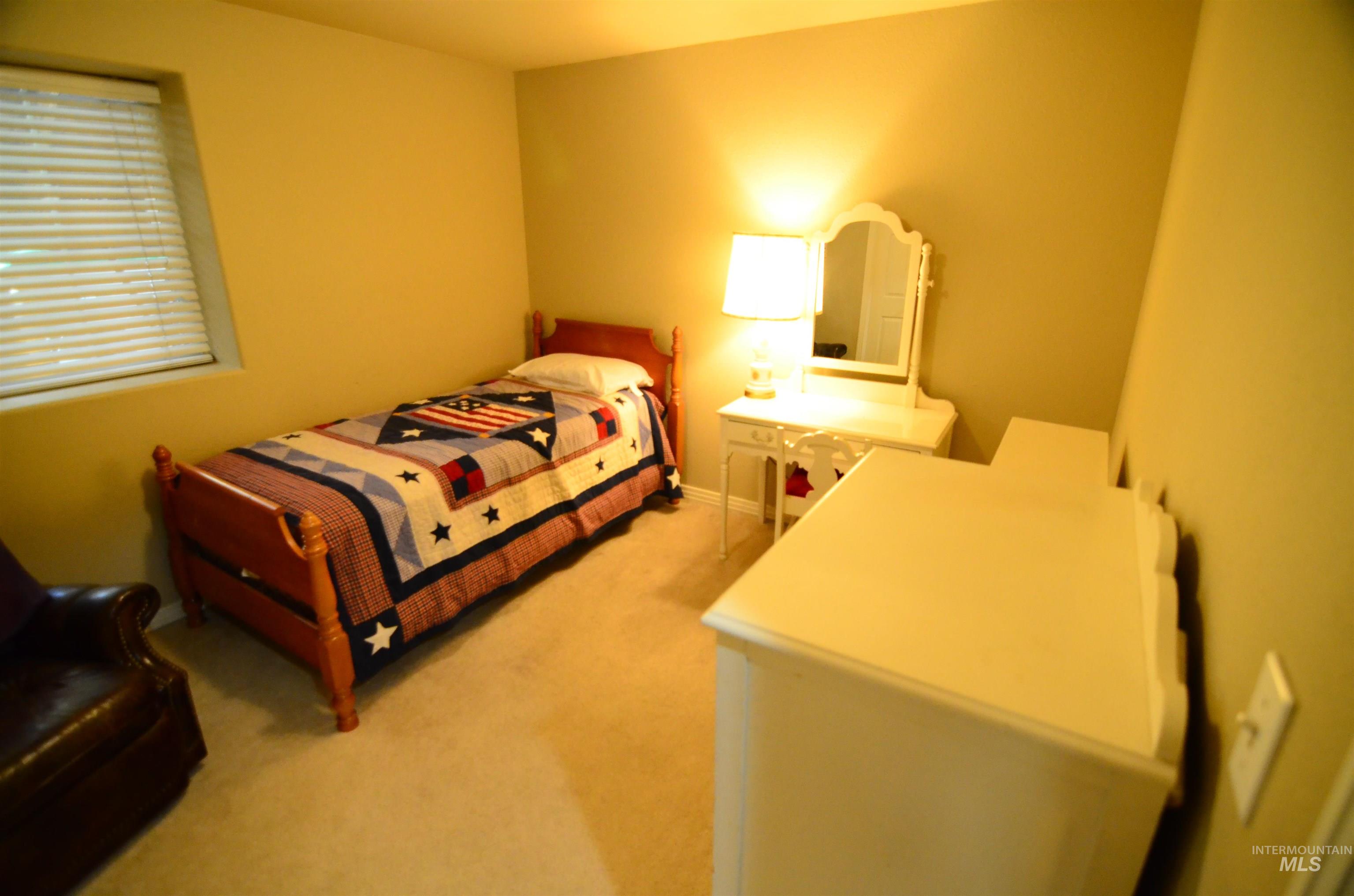 690 Granite Way Boise, ID 83712 - Photo 27 of 30 Bedroom featuring light carpet and baseboards