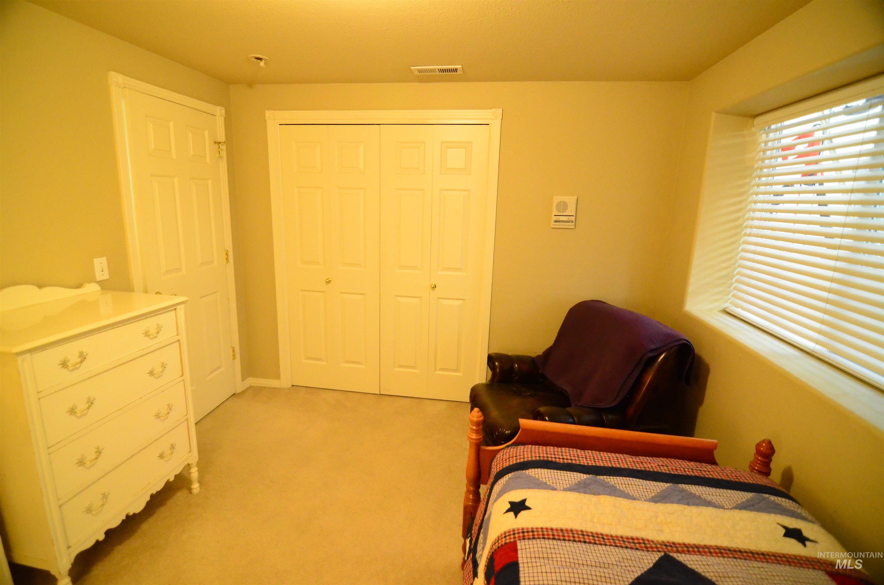 690 Granite Way Boise, ID 83712 - Photo 28 of 30 Bedroom with light carpet and a closet