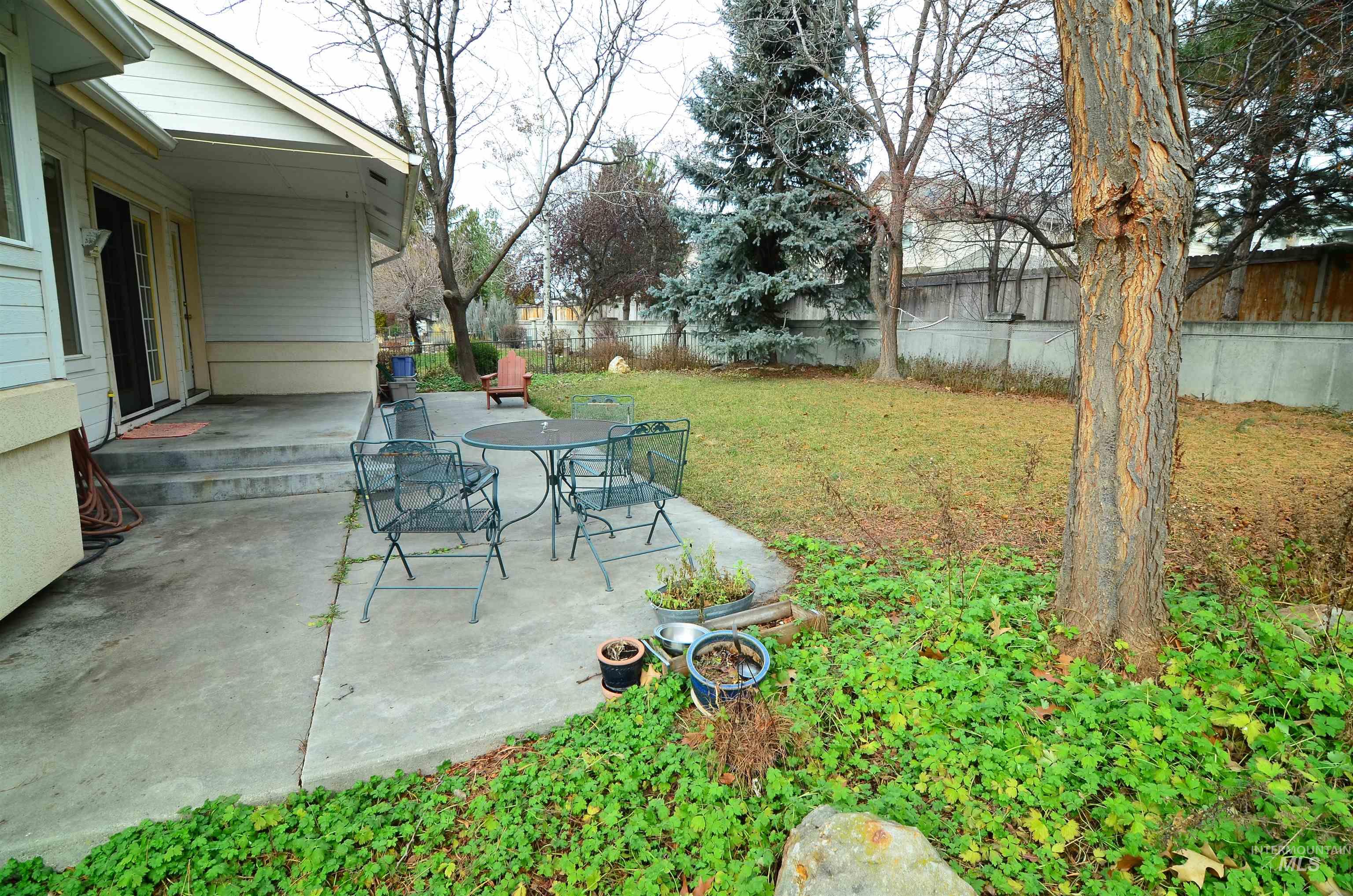 690 Granite Way Boise, ID 83712 - Photo 29 of 30 Fenced backyard featuring a patio and outdoor dining area