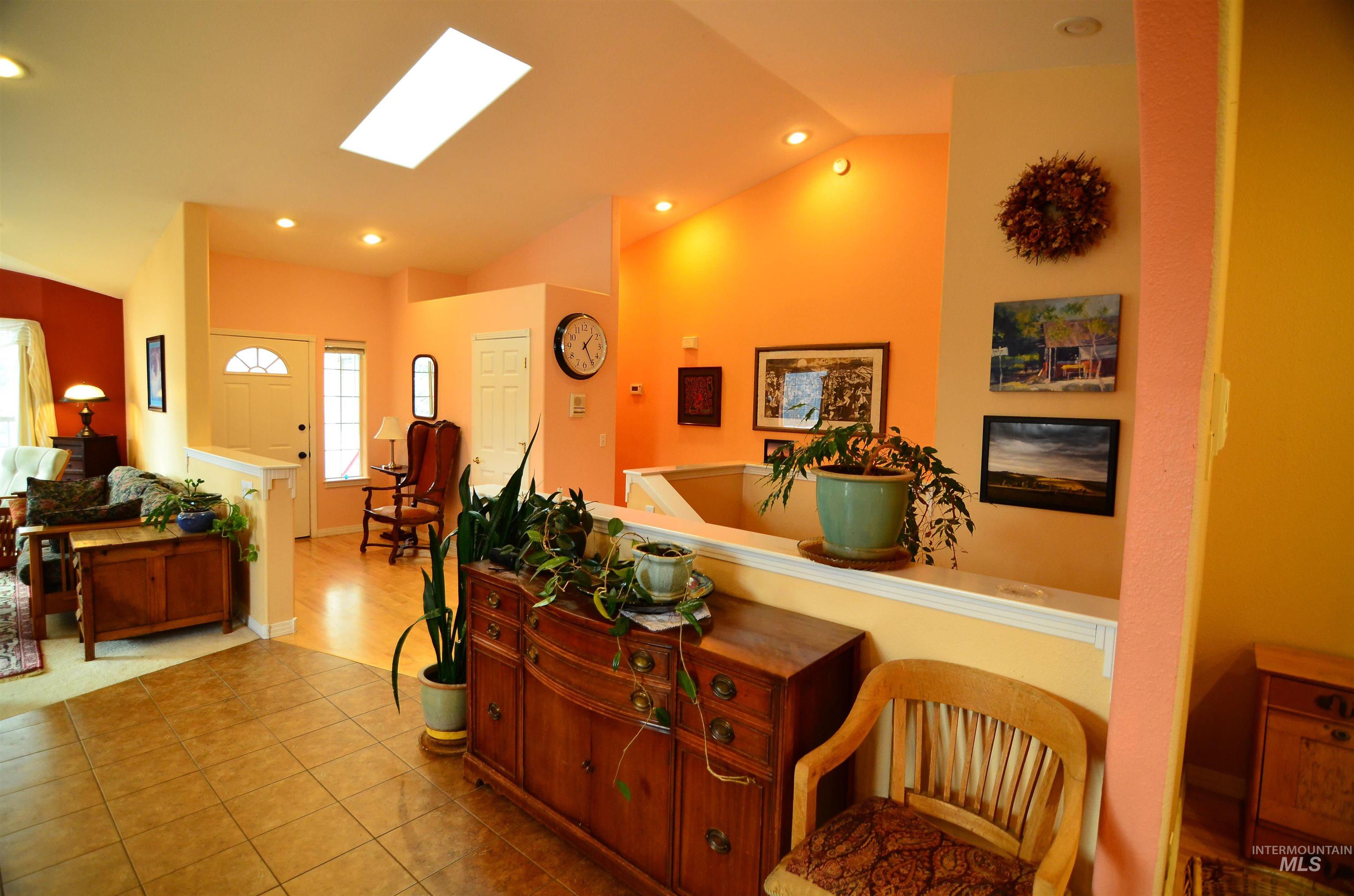 690 Granite Way Boise, ID 83712 - Photo 3 of 30 Living area featuring recessed lighting, lofted ceiling, a skylight, and tile patterned flooring