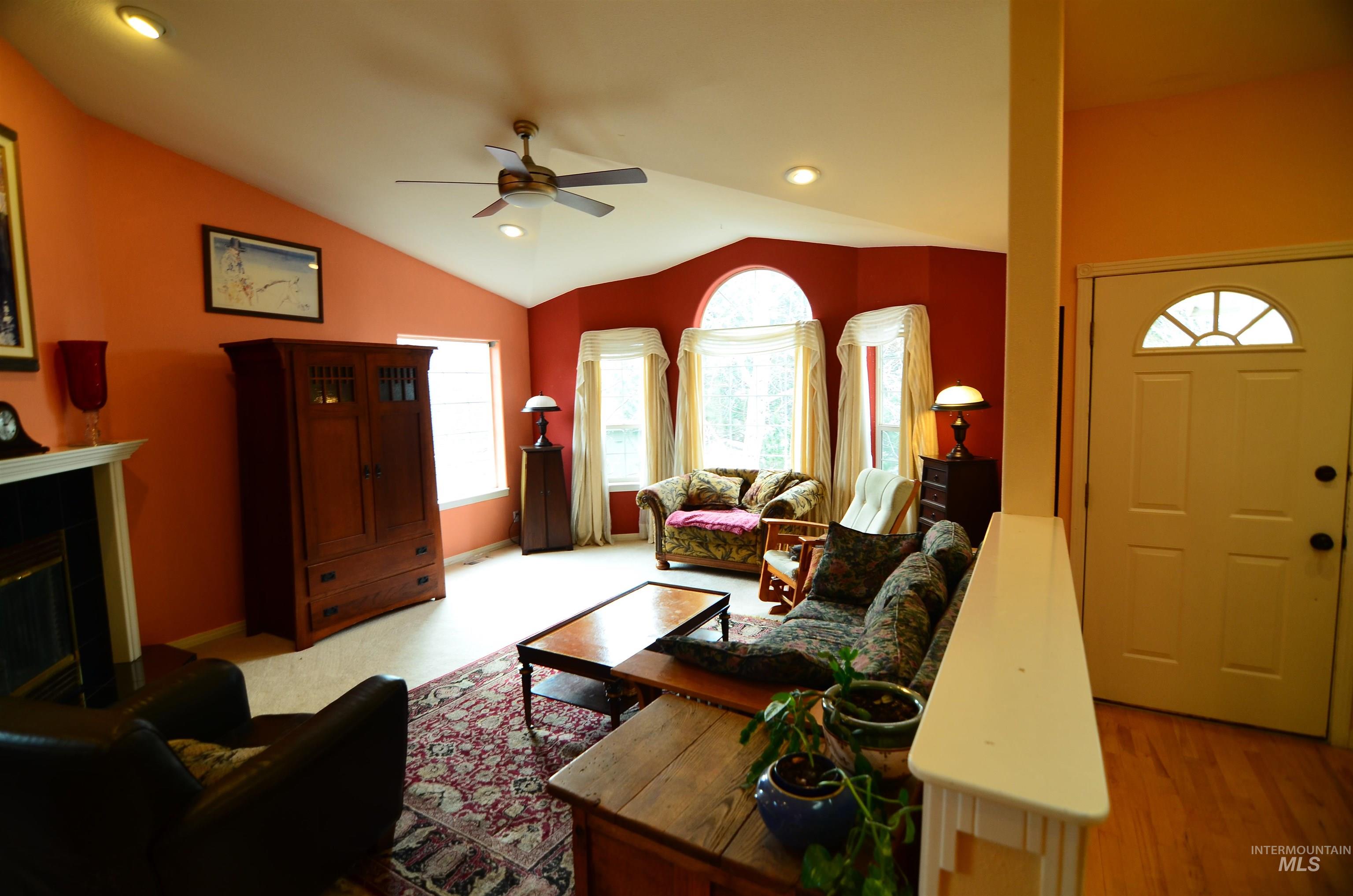 690 Granite Way Boise, ID 83712 - Photo 4 of 30 Living area featuring recessed lighting, a glass covered fireplace, lofted ceiling, and a ceiling fan
