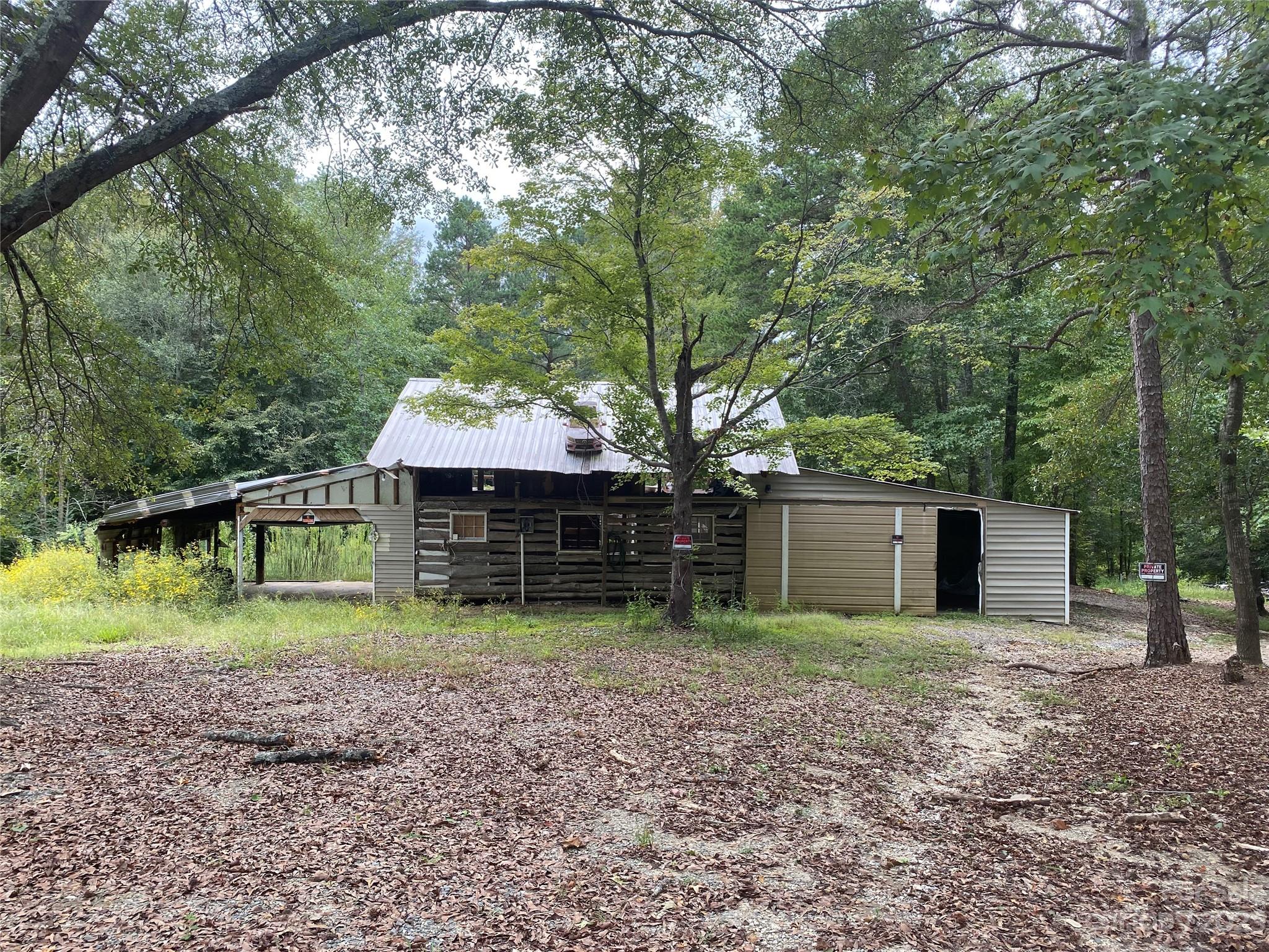 527 Waring Court Fort Mill, SC 29707 - Photo 27 of 31 a view of a backyard with large trees and a small barn