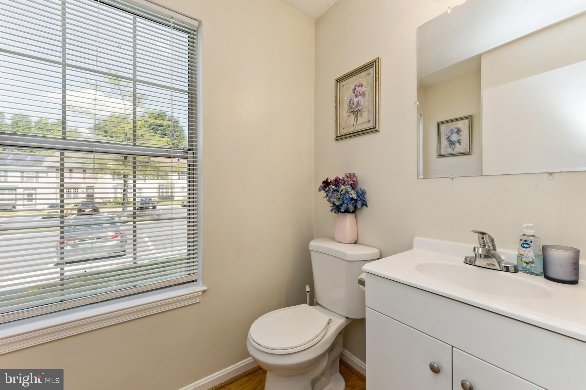 8697 Ritchboro Road District Heights, MD 20747 - Photo 11 of 25 a bathroom with a toilet sink and mirror