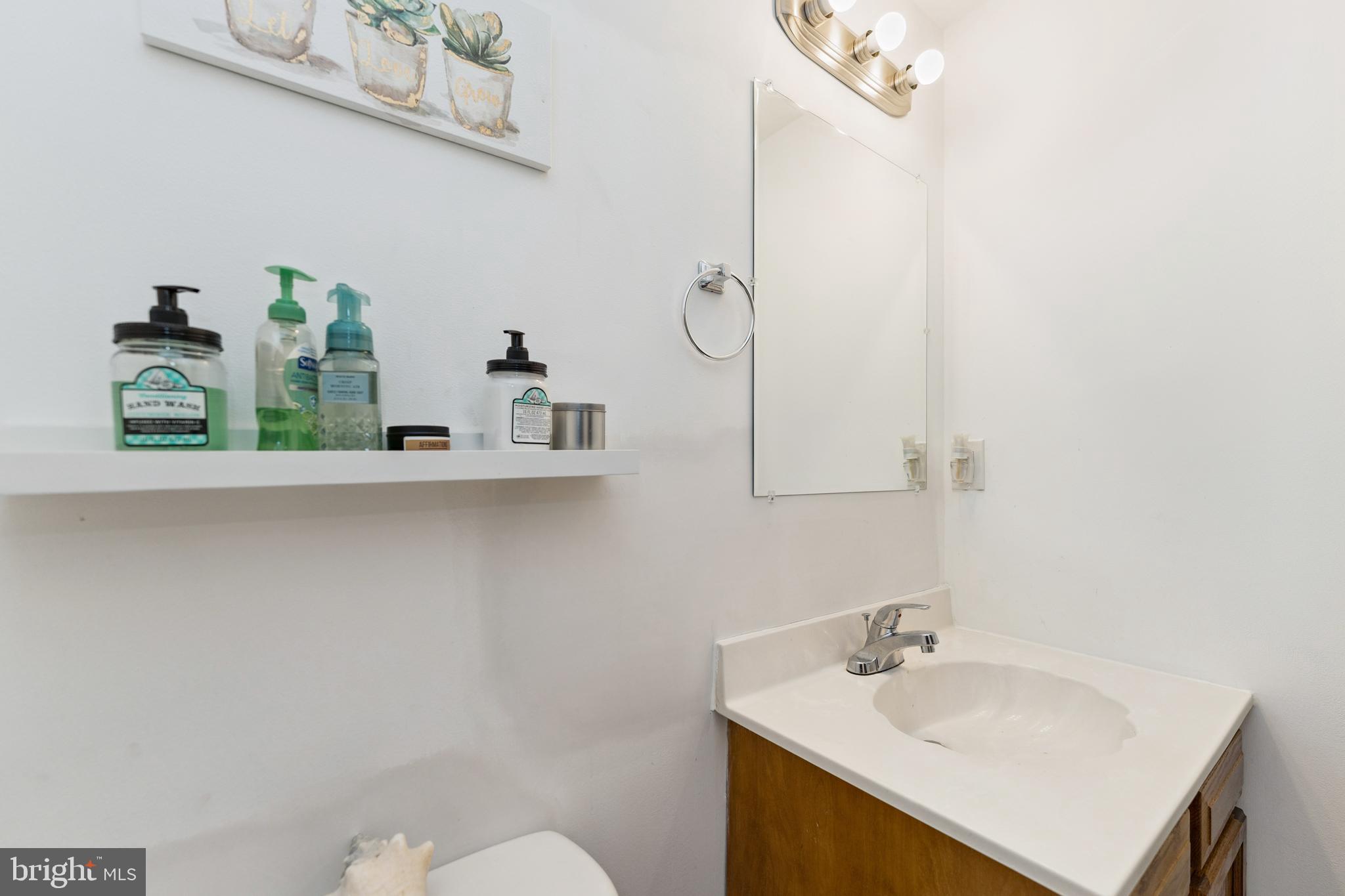 8697 Ritchboro Road District Heights, MD 20747 - Photo 21 of 25 a bathroom with a sink vanity and mirror
