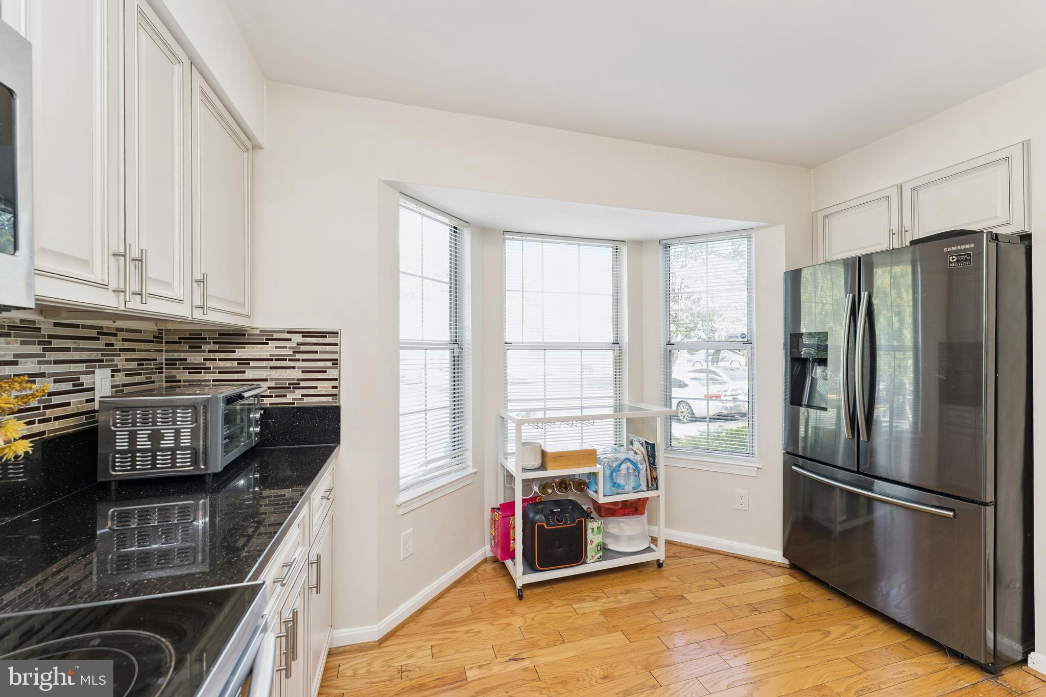 8697 Ritchboro Road District Heights, MD 20747 - Photo 10 of 25 a kitchen with stainless steel appliances a refrigerator sink and cabinets