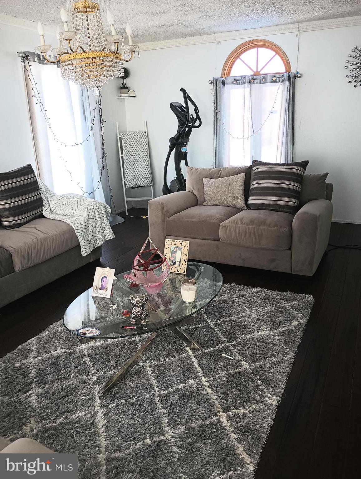 a living room with furniture and a chandelier