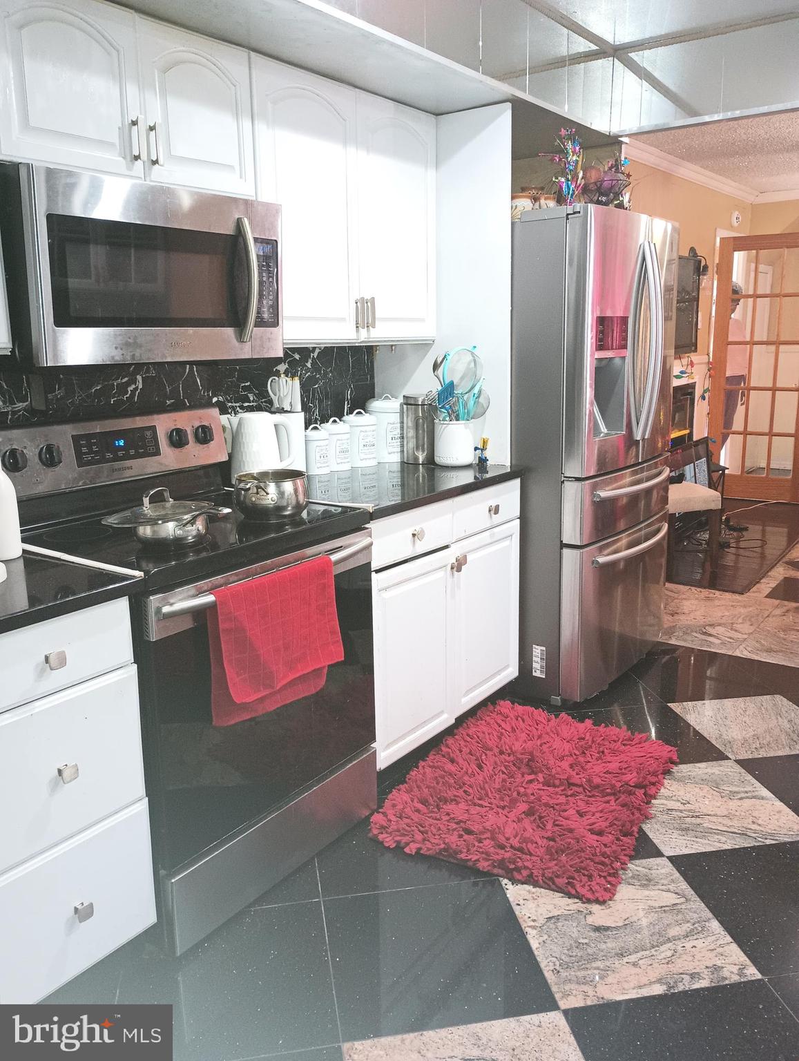 53 Genesee Lane Willingboro, NJ 08046 - Photo 4 of 13 a kitchen with stainless steel appliances kitchen island granite countertop a sink stove and microwave