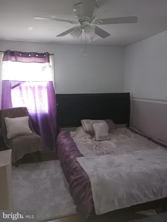 a bedroom with a bed and a mirror