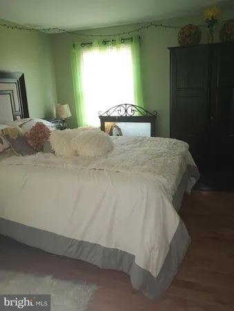 a large bed sitting in a bedroom next to a window