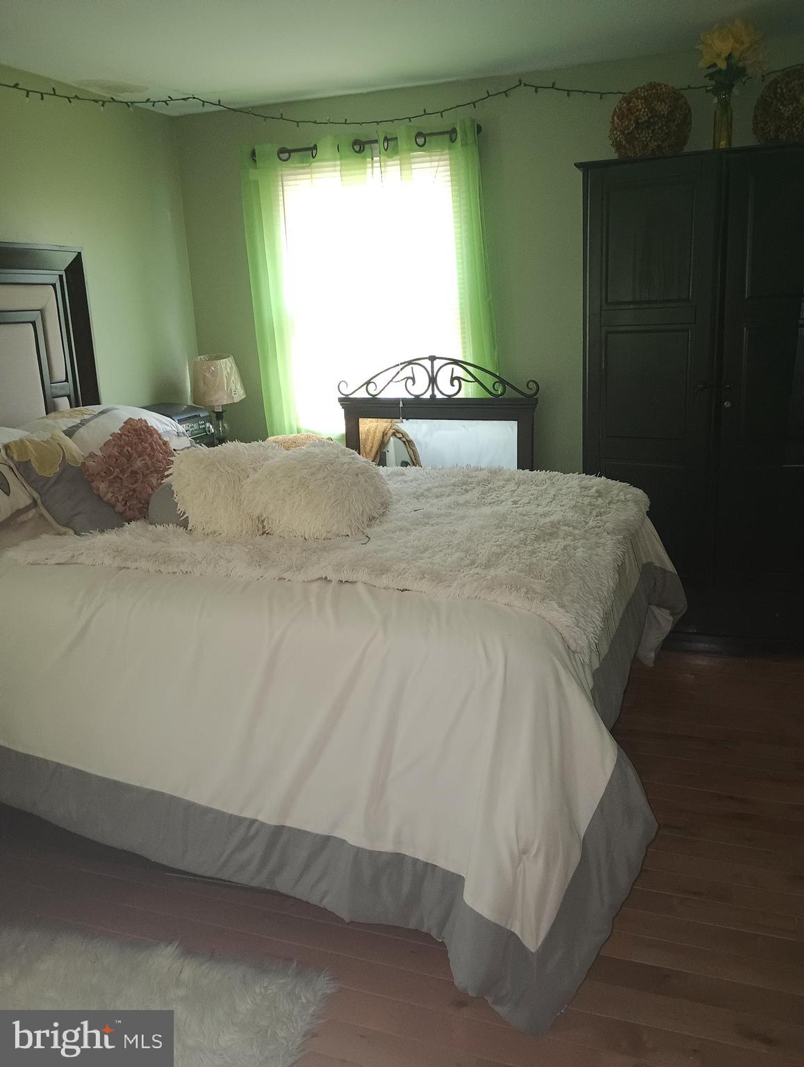 53 Genesee Lane Willingboro, NJ 08046 - Photo 8 of 13 a large bed sitting in a bedroom next to a window