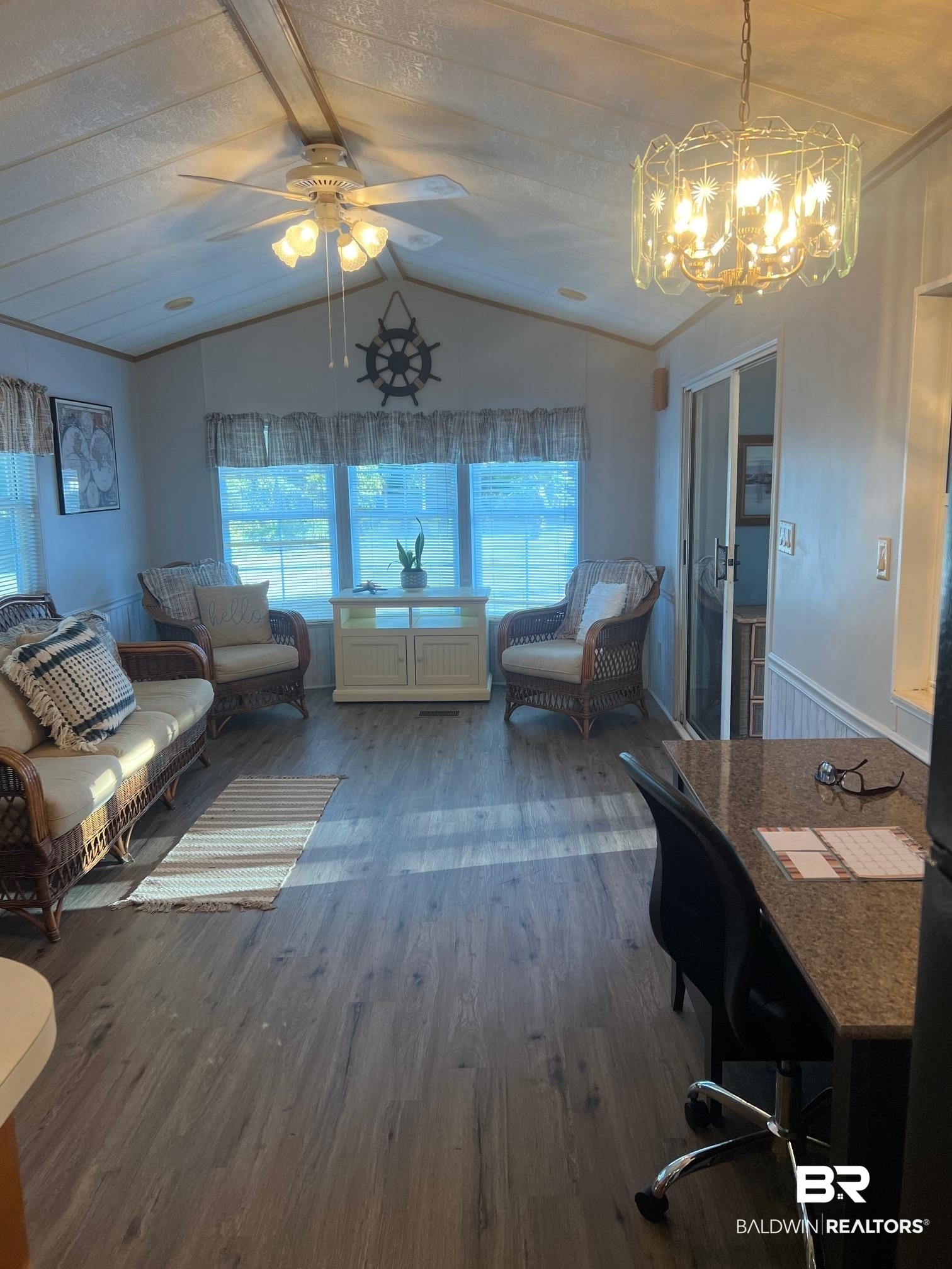 698 Escambia Loop Lillian, AL 36549 - Photo 4 of 16 Interior space with hardwood / wood-style flooring, ceiling fan with notable chandelier, vaulted ceiling, and a textured ceiling