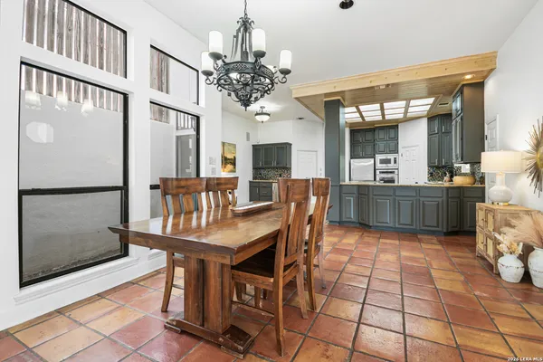 a view of a dining room with furniture and a chandelier