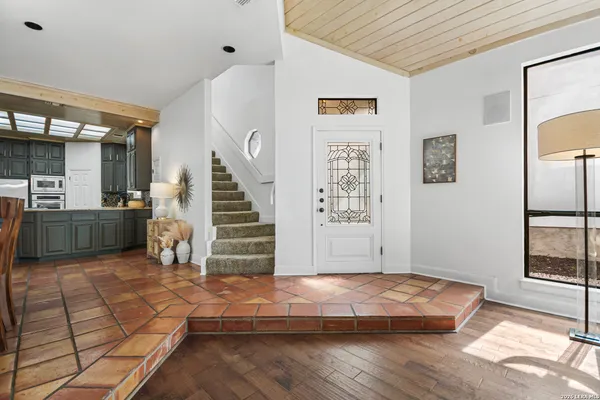 a view of a livingroom with wooden floor and stairs