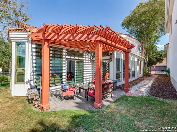 a backyard of a house with barbeque oven table and chairs