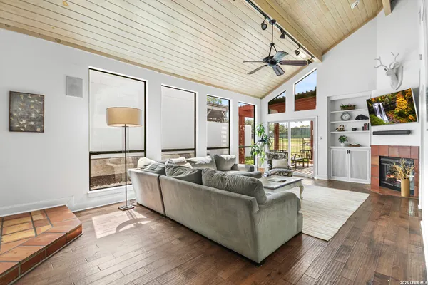 a living room with furniture a fireplace and a flat screen tv