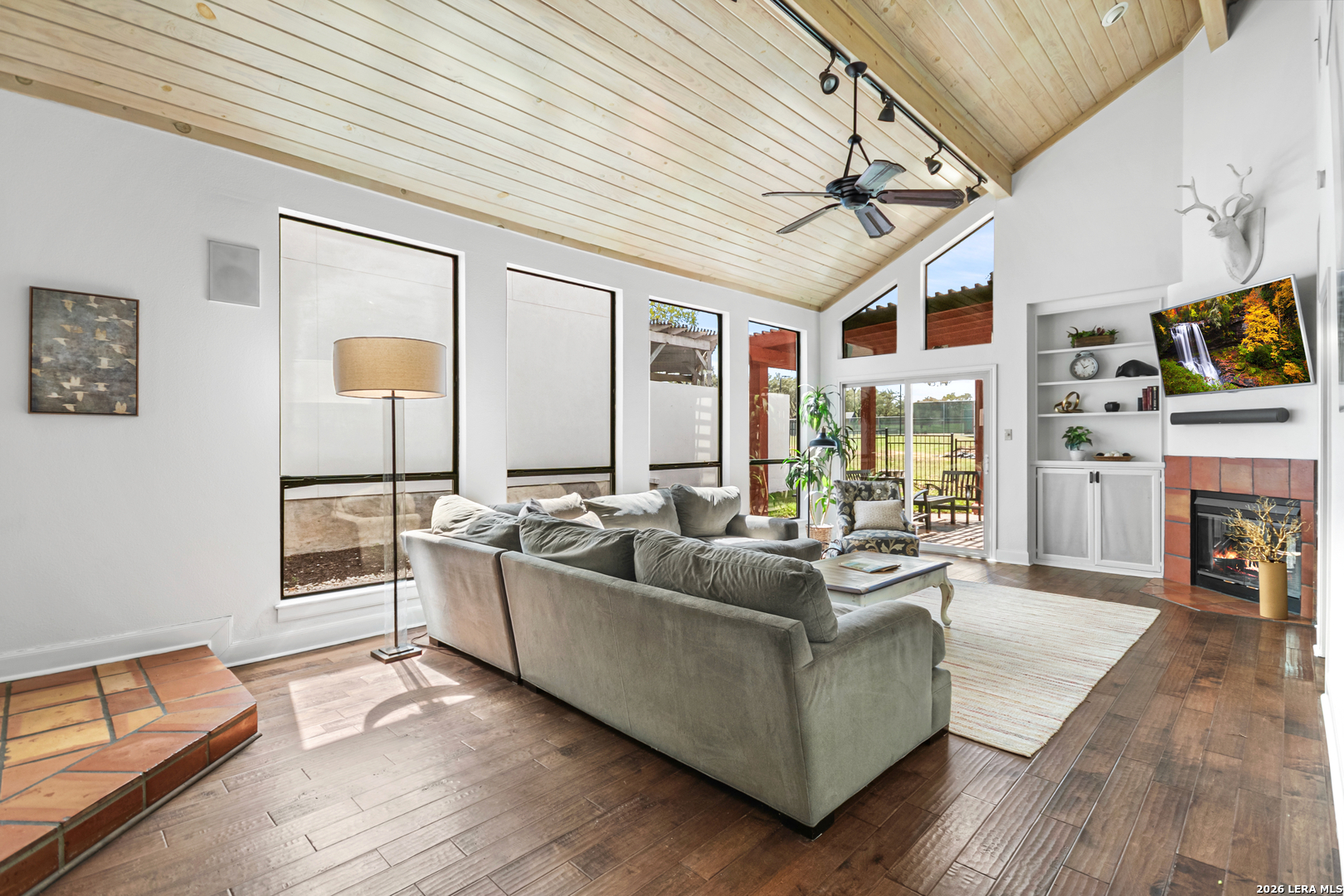 29439 Summit Ridge Drive Fair Oaks Ranch, TX 78015 - Photo 5 of 34 a living room with furniture a fireplace and a flat screen tv
