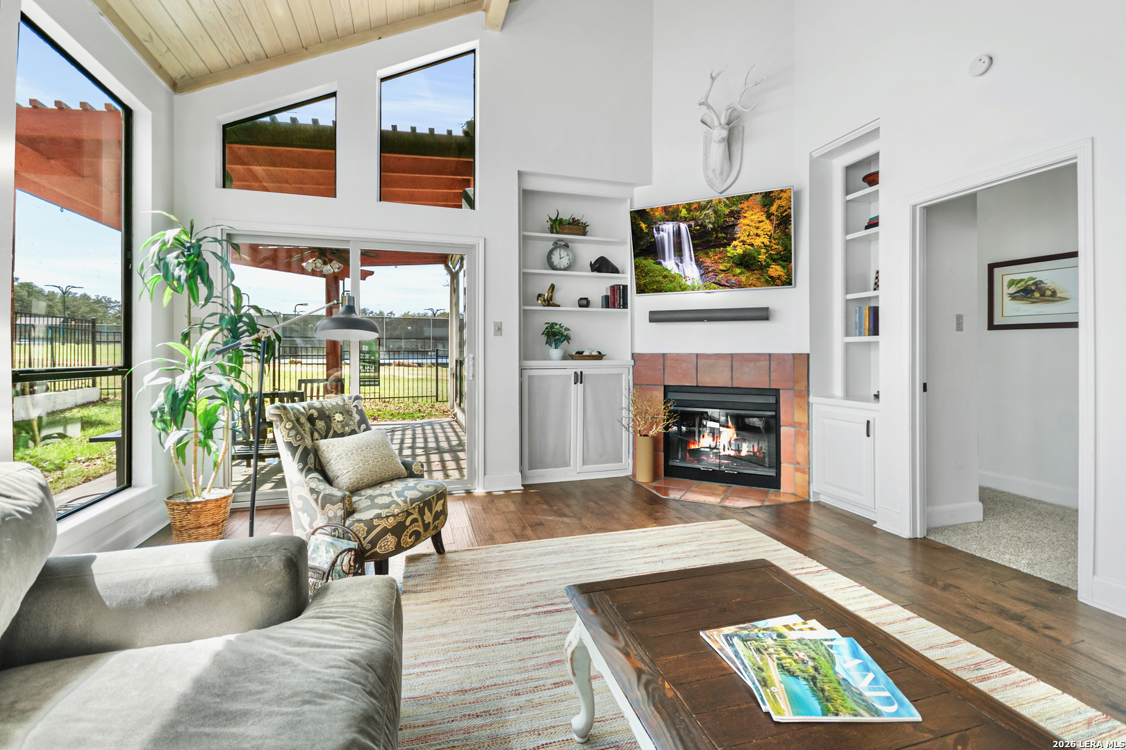 29439 Summit Ridge Drive Fair Oaks Ranch, TX 78015 - Photo 10 of 34 a living room with furniture a rug wooden floor and a fireplace