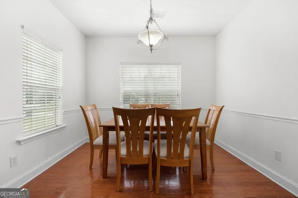 a view of a dining room with furniture window and wooden floor