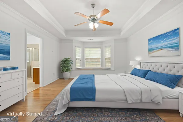 a bedroom with a large bed and a chandelier