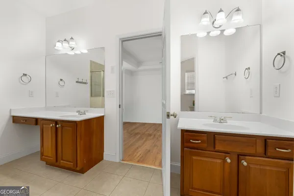 a bathroom with a sink vanity and a mirror