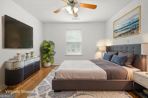 a bedroom with a bed and a flat screen tv
