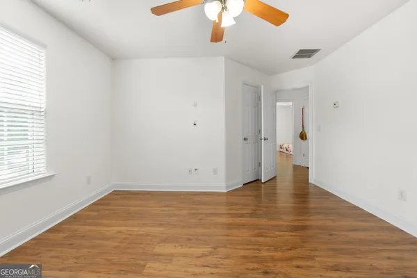 a view of a room with wooden floor and window