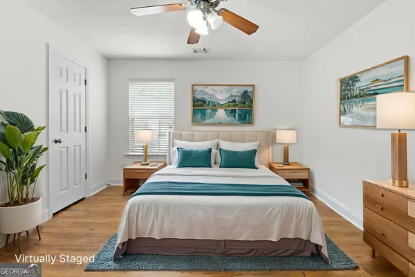 a bedroom with bed and a potted plant