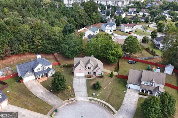 an aerial view of residential houses with outdoor space