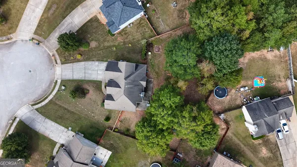 an aerial view of a house with garden space and street view