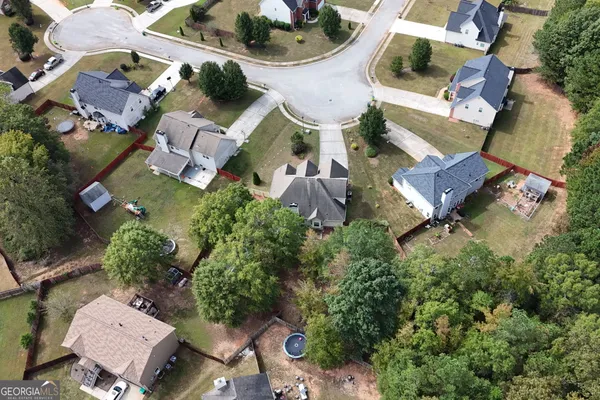 an aerial view of residential house with outdoor space and parking