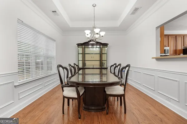 a view of a dining room with furniture window and wooden floor