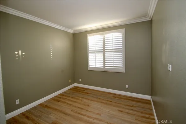 a view of a room with wooden floor and windows