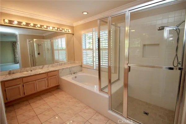 a spacious bathroom with a tub shower and sink