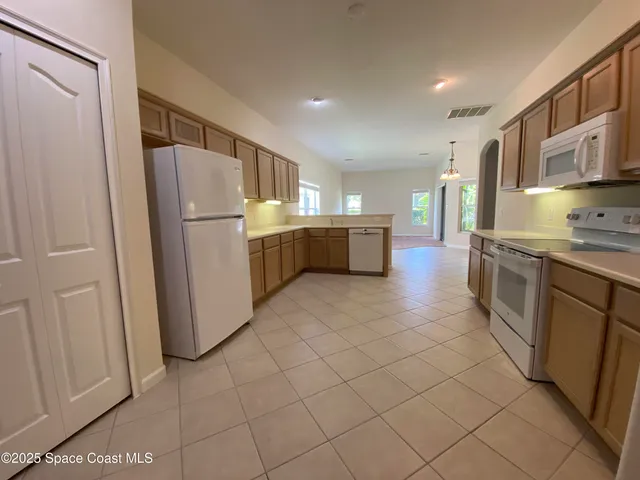 a kitchen with a refrigerator and a sink