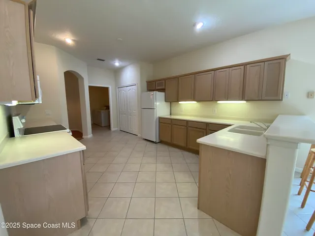 a kitchen with stainless steel appliances a refrigerator and a stove top oven
