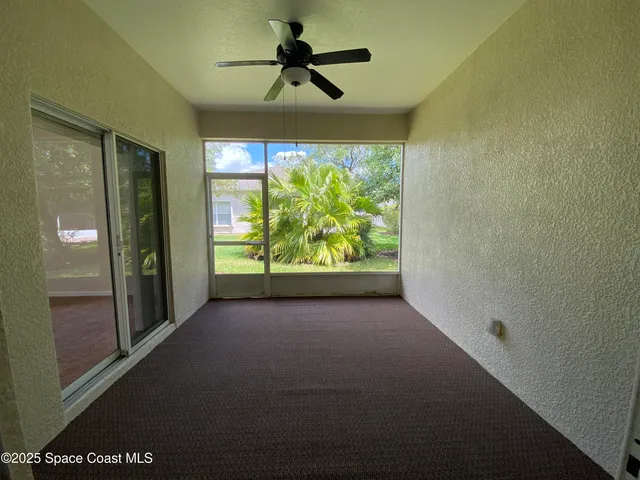 a view of room with window and ceiling fan